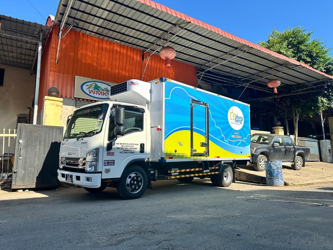 Isuzu truck with a blue and yellow refrigerated body parked at the WMK Cold Room workshop