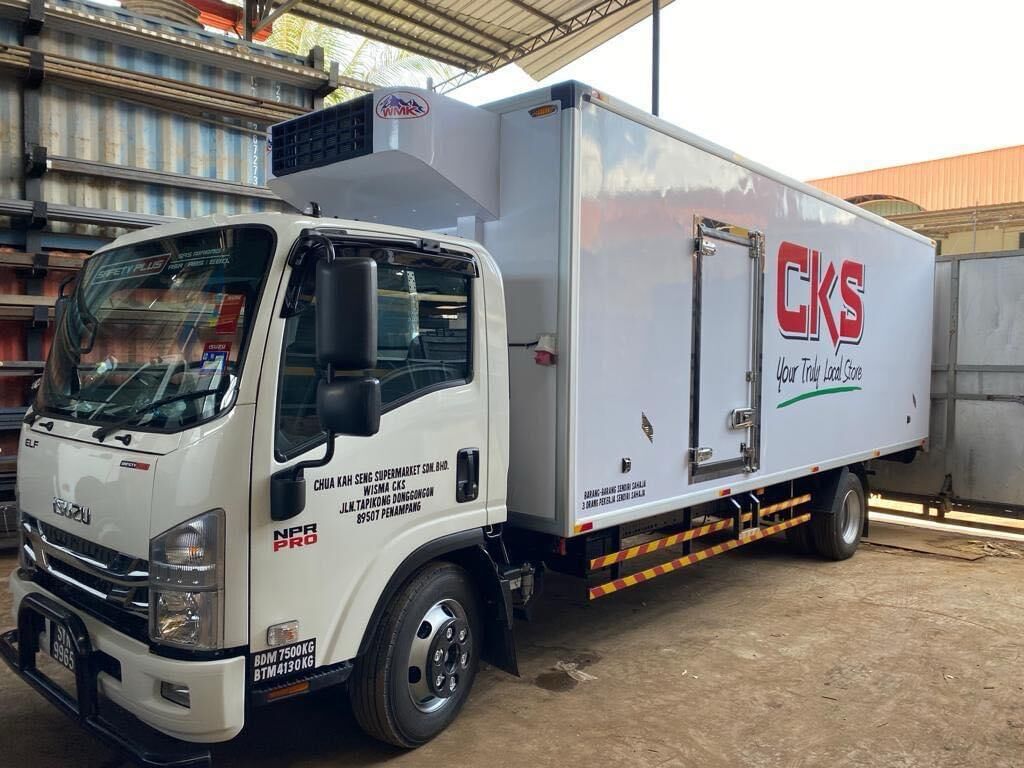 Isuzu truck with a white refrigerated body